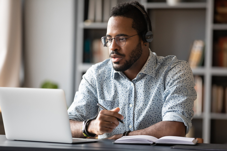 Businessperson Wearing Headphones Study Online Watching Webinar