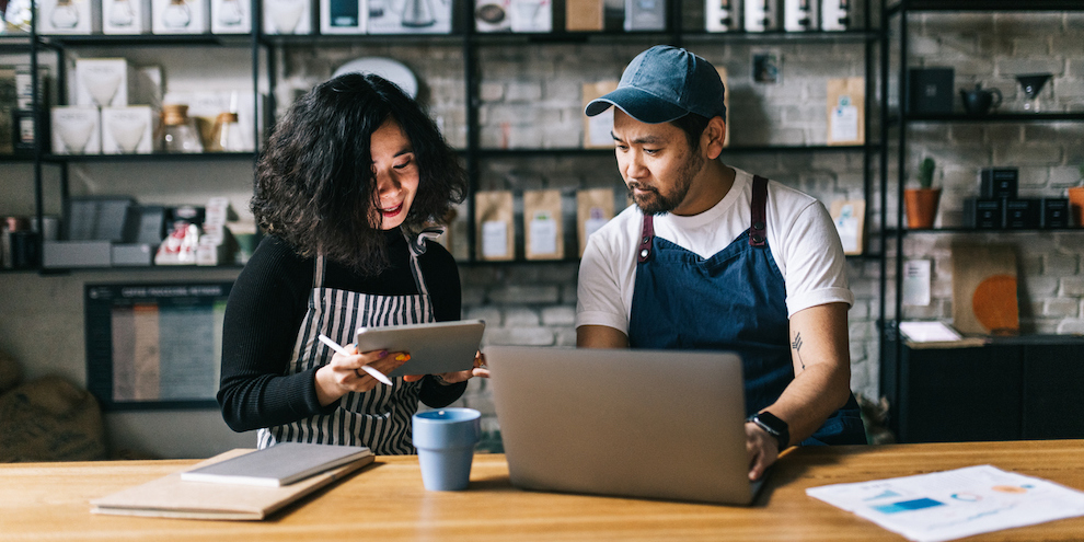 Two small business owners discussing AI adoption.