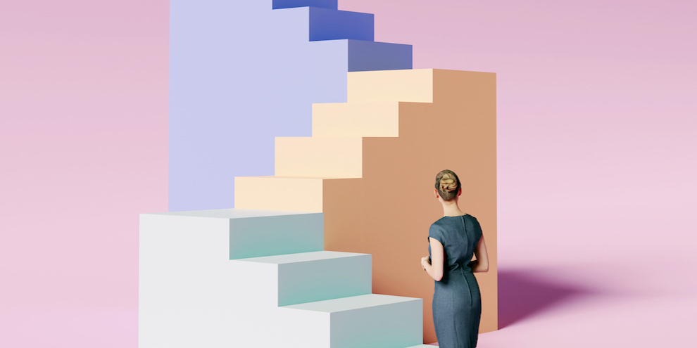 A woman facing colorful stairs.