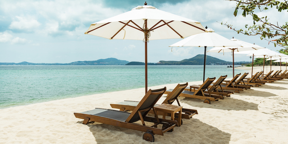 Chairs and umbrellas on a beach.