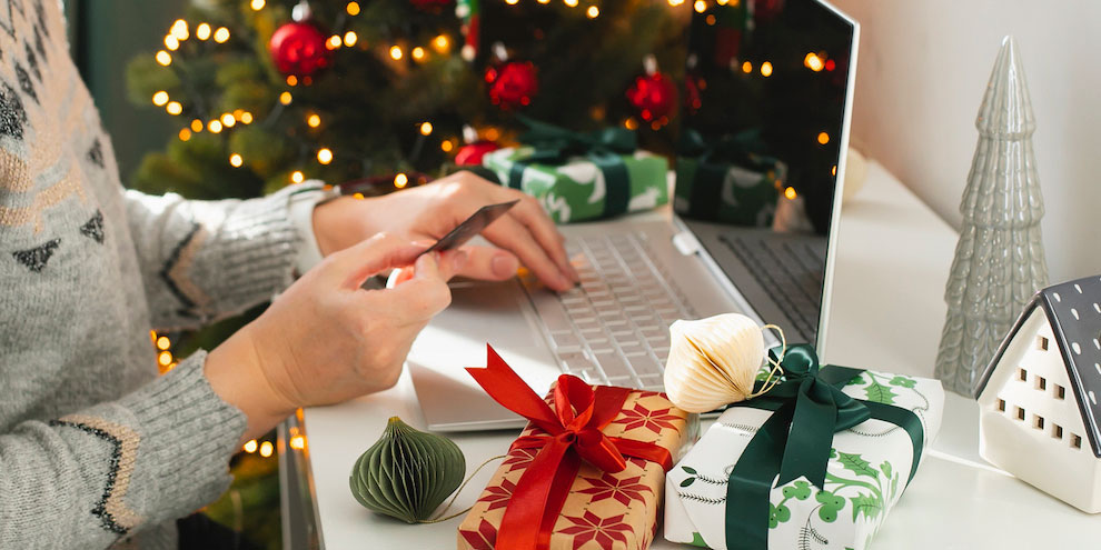 A person using a laptop to purchase a holiday gift.