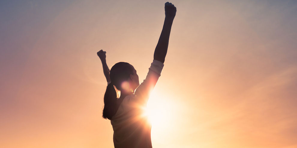 A woman cheering as women sports gain momentum.