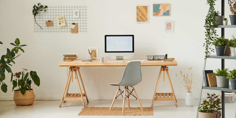 An office with decorations on the desk and wall art.